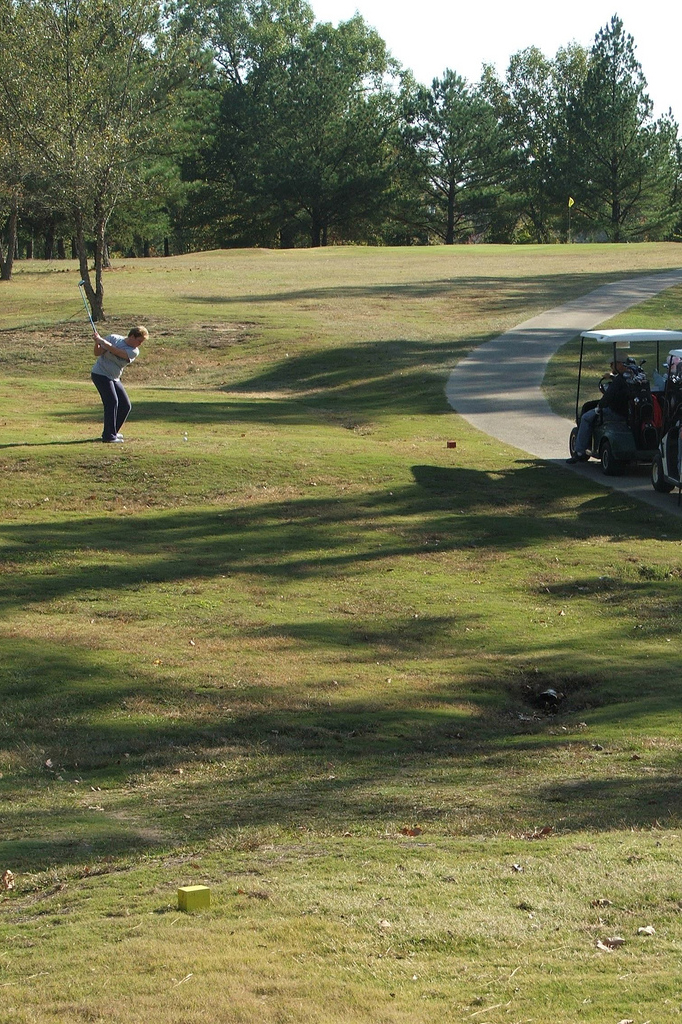 girl chipping at green